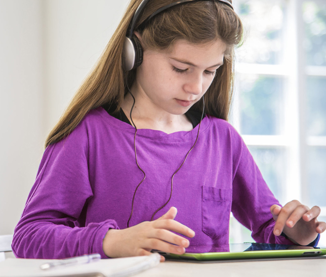 Girl with tablet listening to an audio book