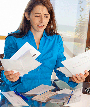 Disorganized woman frustrated with papers and bills