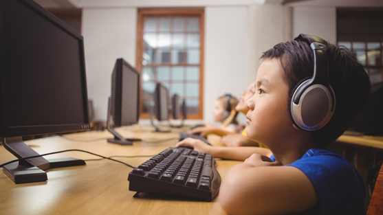 boy at computer with headphones