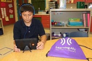 Student using tablet to read audiobooks